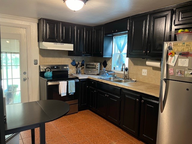 1505 Maple Street Georgetown, TX 78626 - Photo 6 of 20 a kitchen with stainless steel appliances granite countertop a sink refrigerator stove and microwave