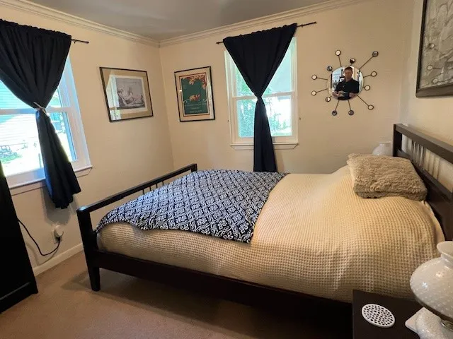a bedroom with bed and wooden floor