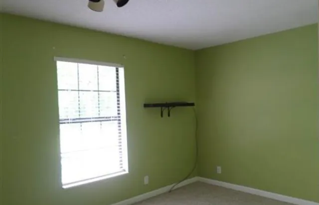 a view of room with wooden floor