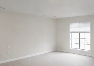 a view of an empty room with a window