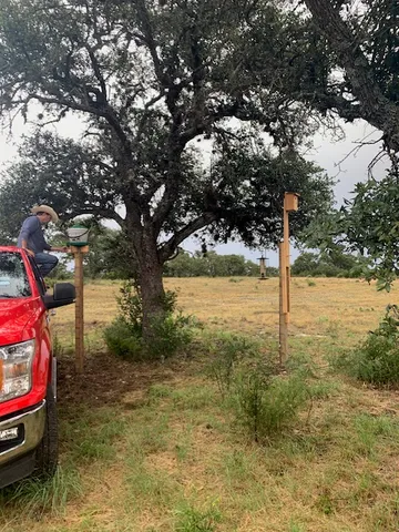 a backyard of a house with lots of green space and fountain