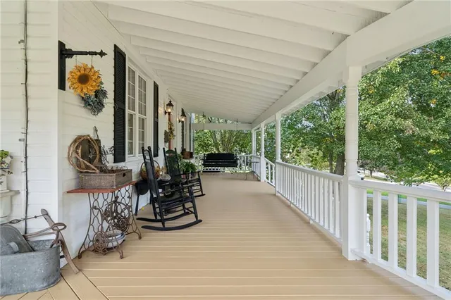 a view of a patio with chairs and potted plants