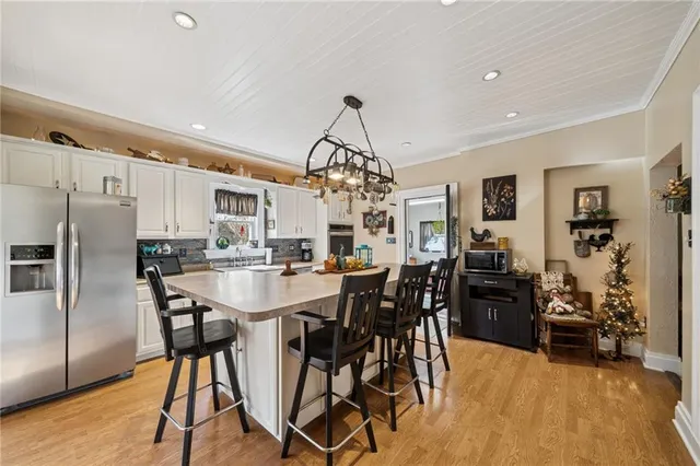 a view of a dining room with furniture and chandelier