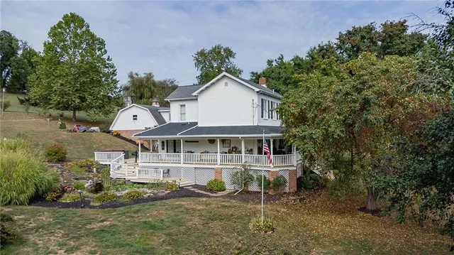 an aerial view of a house with a yard and balcony