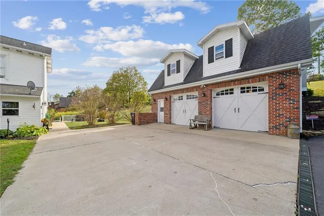 a view of a house with a yard and garage