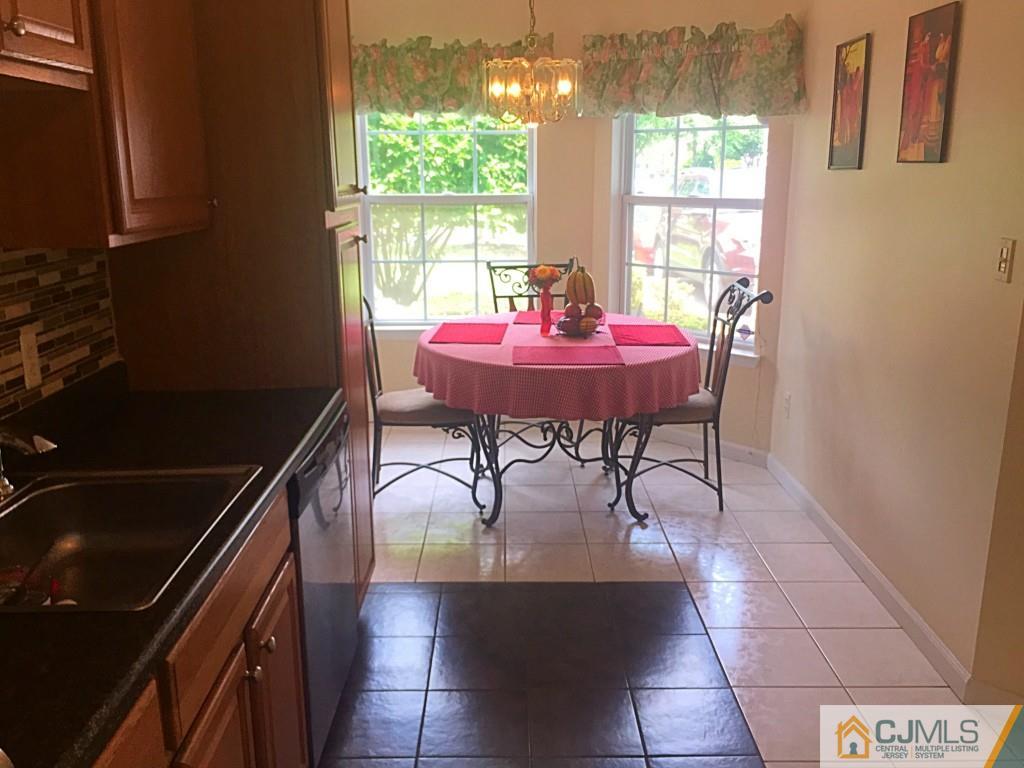 384 Draco Road Piscataway, NJ 08854 - Photo 4 of 19 a view of a dining room with furniture and window