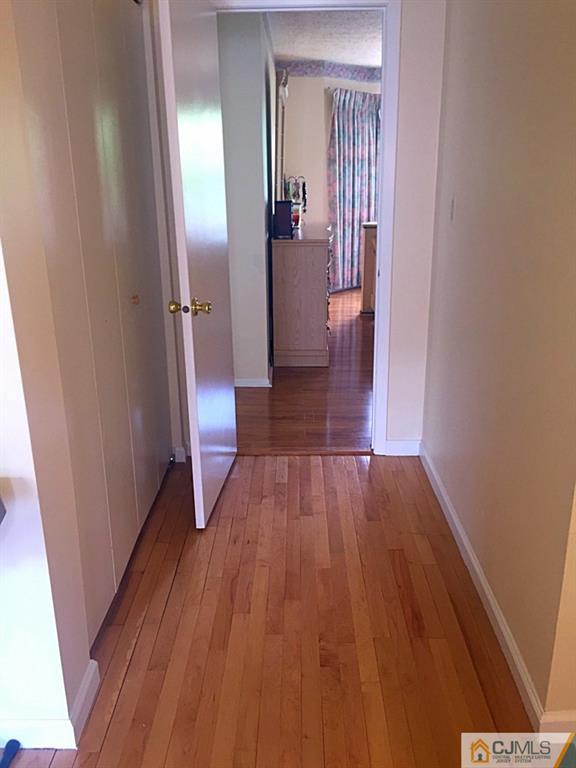 384 Draco Road Piscataway, NJ 08854 - Photo 10 of 19 a view of a hallway view with wooden floor