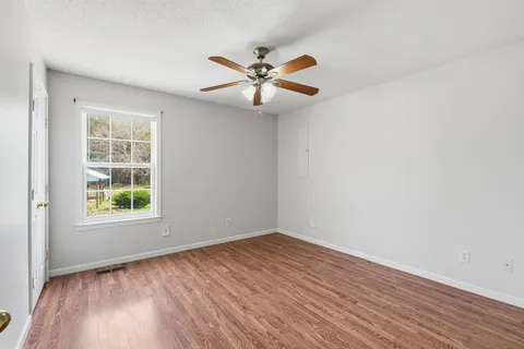 wooden floor in an empty room with a window