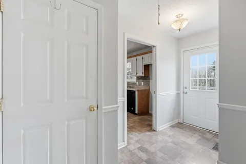 an empty room with windows and closet