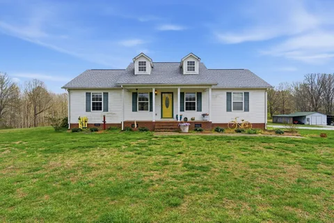 a front view of house with yard and green space