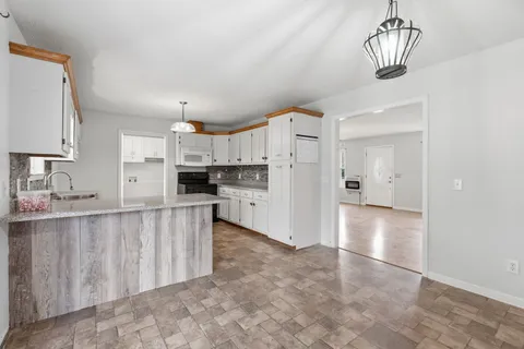 a kitchen with stainless steel appliances a refrigerator sink and cabinets