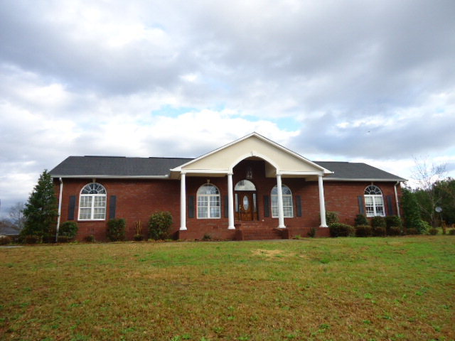 4587 Jones Road Macon, GA 31216 - Photo 1 of 1 a front view of house with yard and green space