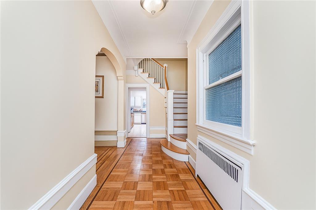1917 Glenwood Road Brooklyn, NY 11230 - Photo 15 of 36 a view of a hallway with wooden floor and staircase
