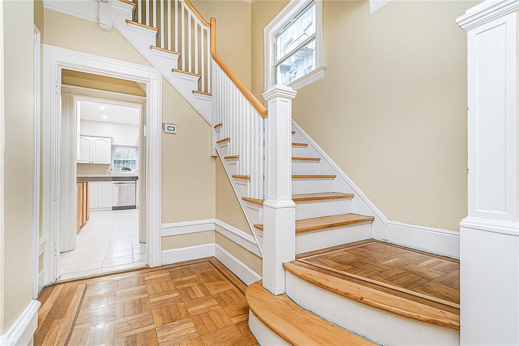 1917 Glenwood Road Brooklyn, NY 11230 - Photo 16 of 36 a view of staircase with white walls and a next to a window