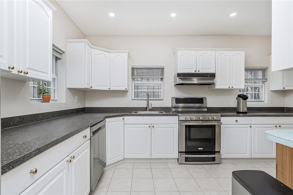 1917 Glenwood Road Brooklyn, NY 11230 - Photo 17 of 36 a kitchen with cabinets stainless steel appliances a sink and a stove