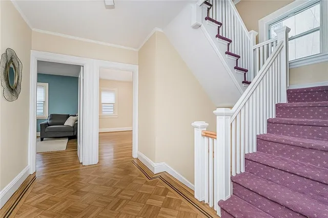 a view of entryway and hall with wooden floor