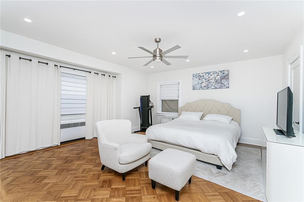 1917 Glenwood Road Brooklyn, NY 11230 - Photo 23 of 36 a bedroom with a bed furniture and a flat screen tv