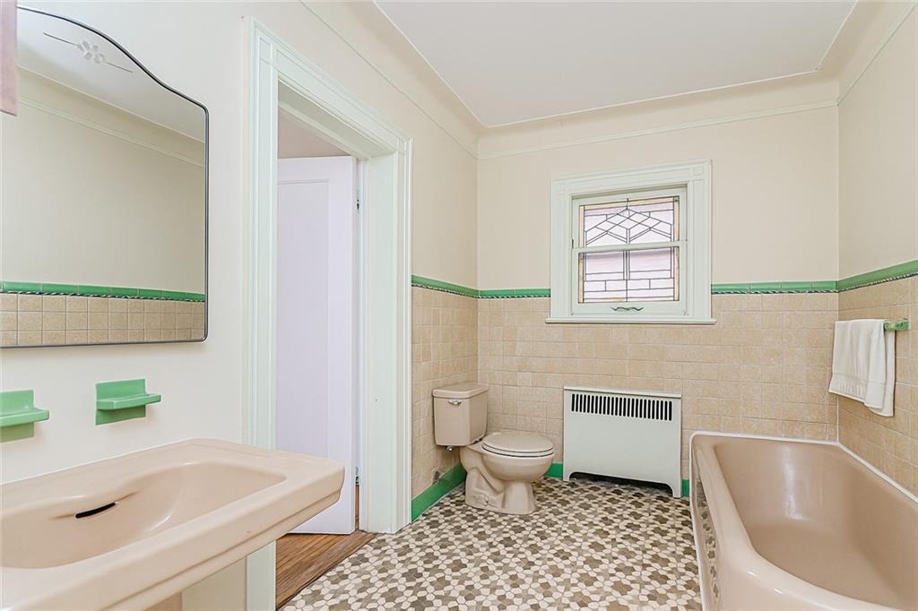 1917 Glenwood Road Brooklyn, NY 11230 - Photo 24 of 36 a bathroom with a sink toilet a bathtub and a shower