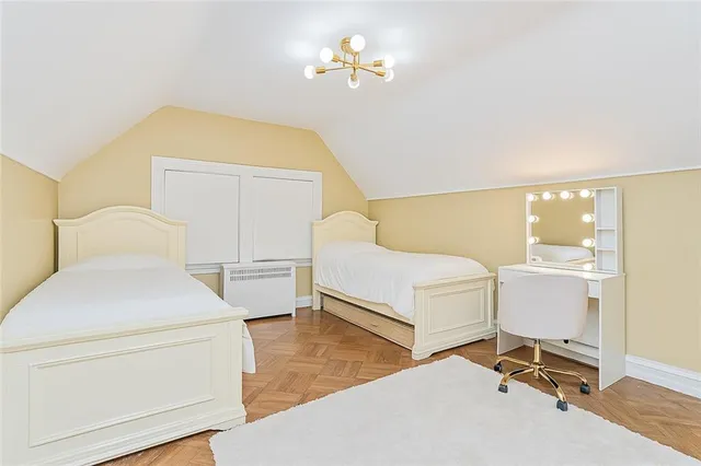 a bedroom with a bed and a chandelier