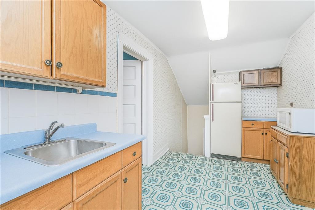 1917 Glenwood Road Brooklyn, NY 11230 - Photo 29 of 36 a kitchen with stainless steel appliances granite countertop a sink and a refrigerator