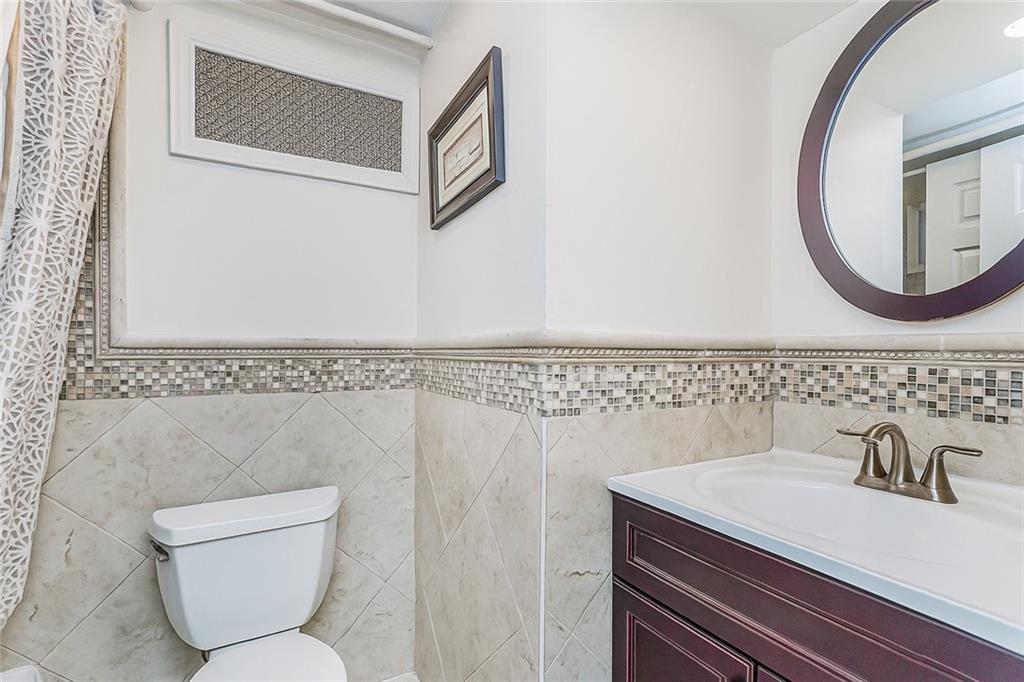 1917 Glenwood Road Brooklyn, NY 11230 - Photo 34 of 36 a bathroom with a sink and a mirror