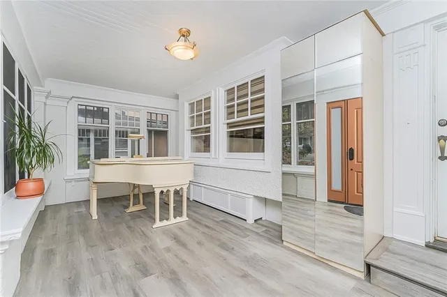 a view of a house with wooden deck and furniture