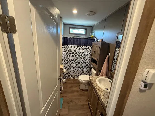 a room with furniture a flat screen tv and a window