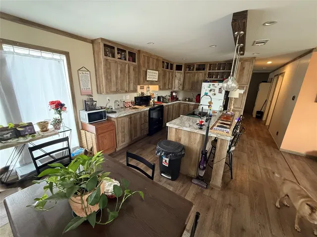 a view of a livingroom with furniture staircase and a dining table