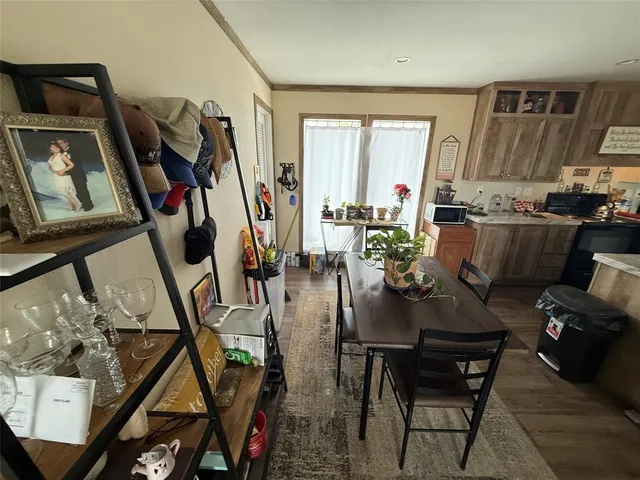 a bedroom with bed mirror and window