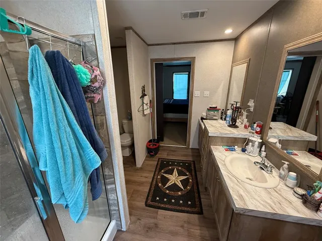 a bathroom with a shower and a glass door shower