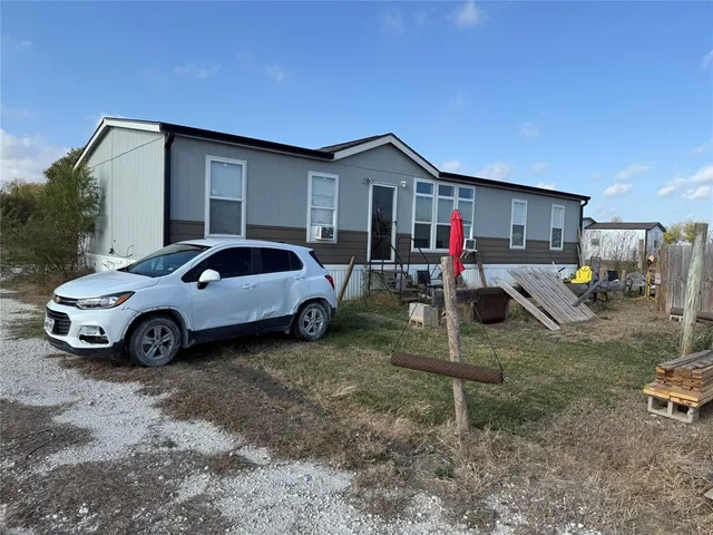 a view of a dry yard with trees