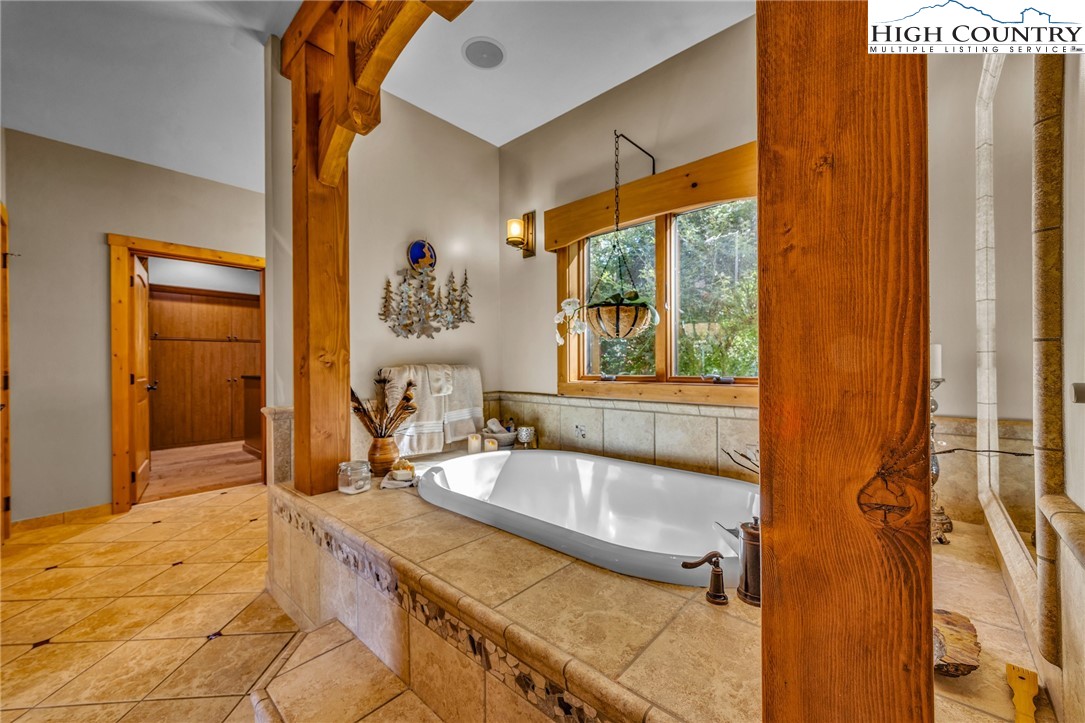 2650 Carson Woods Road Laurel Springs, NC 28644 - Photo 20 of 50 a bathroom with a tub and a sink