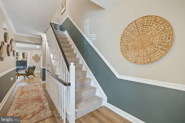 a view of a hallway with wooden floor and entryway