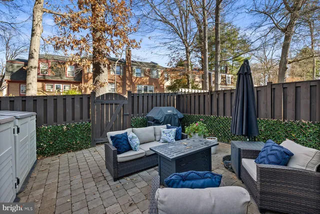 a view of a patio with couches chairs and a fire pit