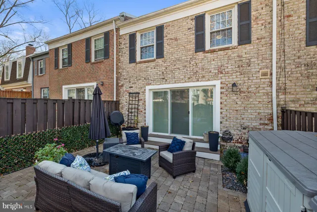 a view of a patio with couches table and chairs and potted plants