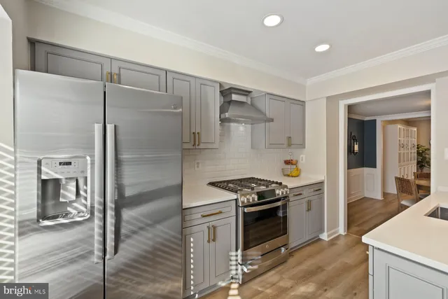 a kitchen with stainless steel appliances granite countertop a stove and a refrigerator