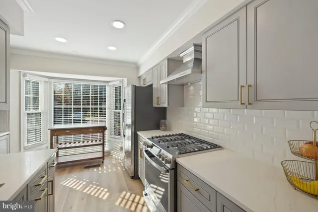 a kitchen with a stove and a white cabinets