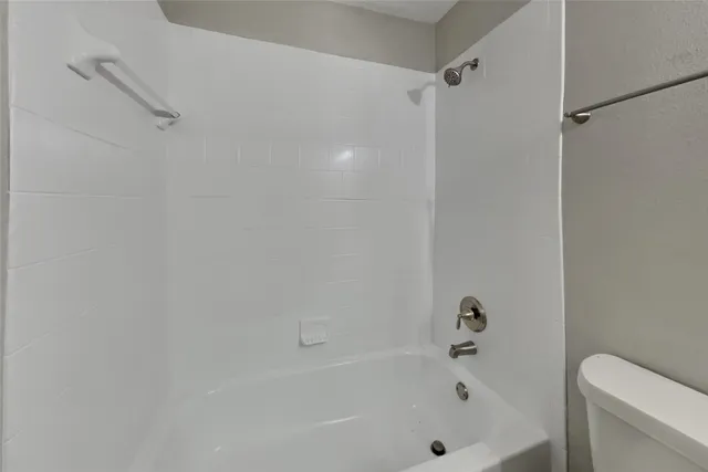 a bathroom with a bathtub and a toilet