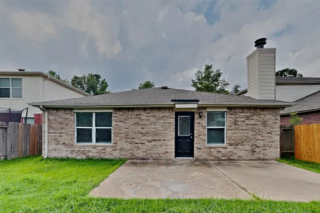 a front view of a house with a garden and plants
