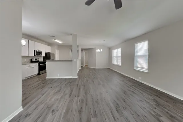 a view of a kitchen with a sink and wooden floor