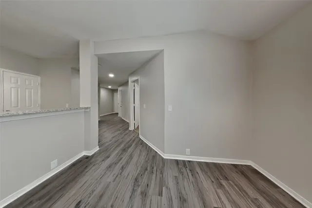a view of a room with wooden floor and a window