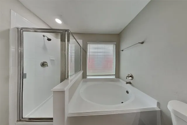 a bathroom with a bathtub and a shower
