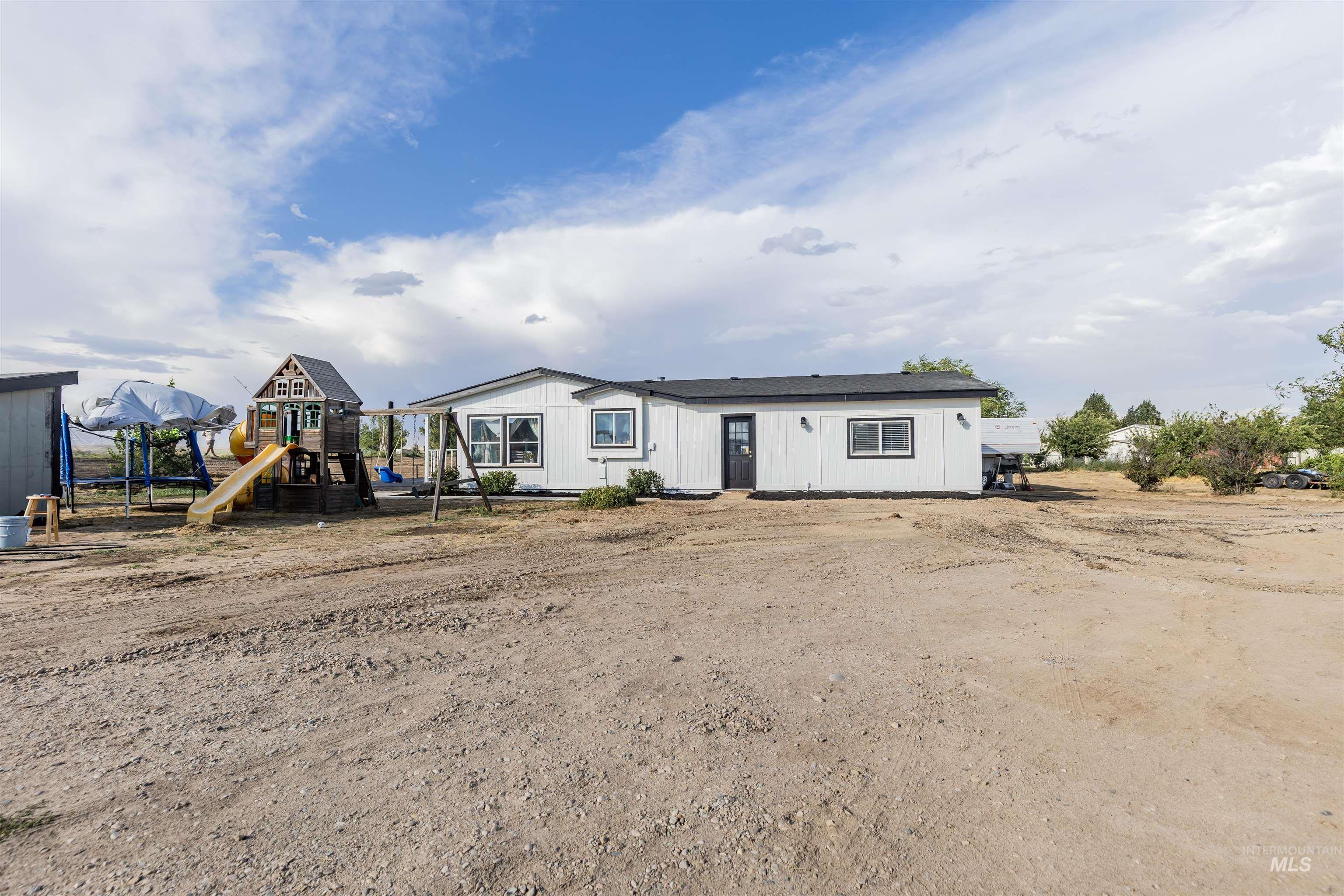 21710 Wood Lane Parma, ID 83660 - Photo 15 of 15 View of front of house featuring a playground