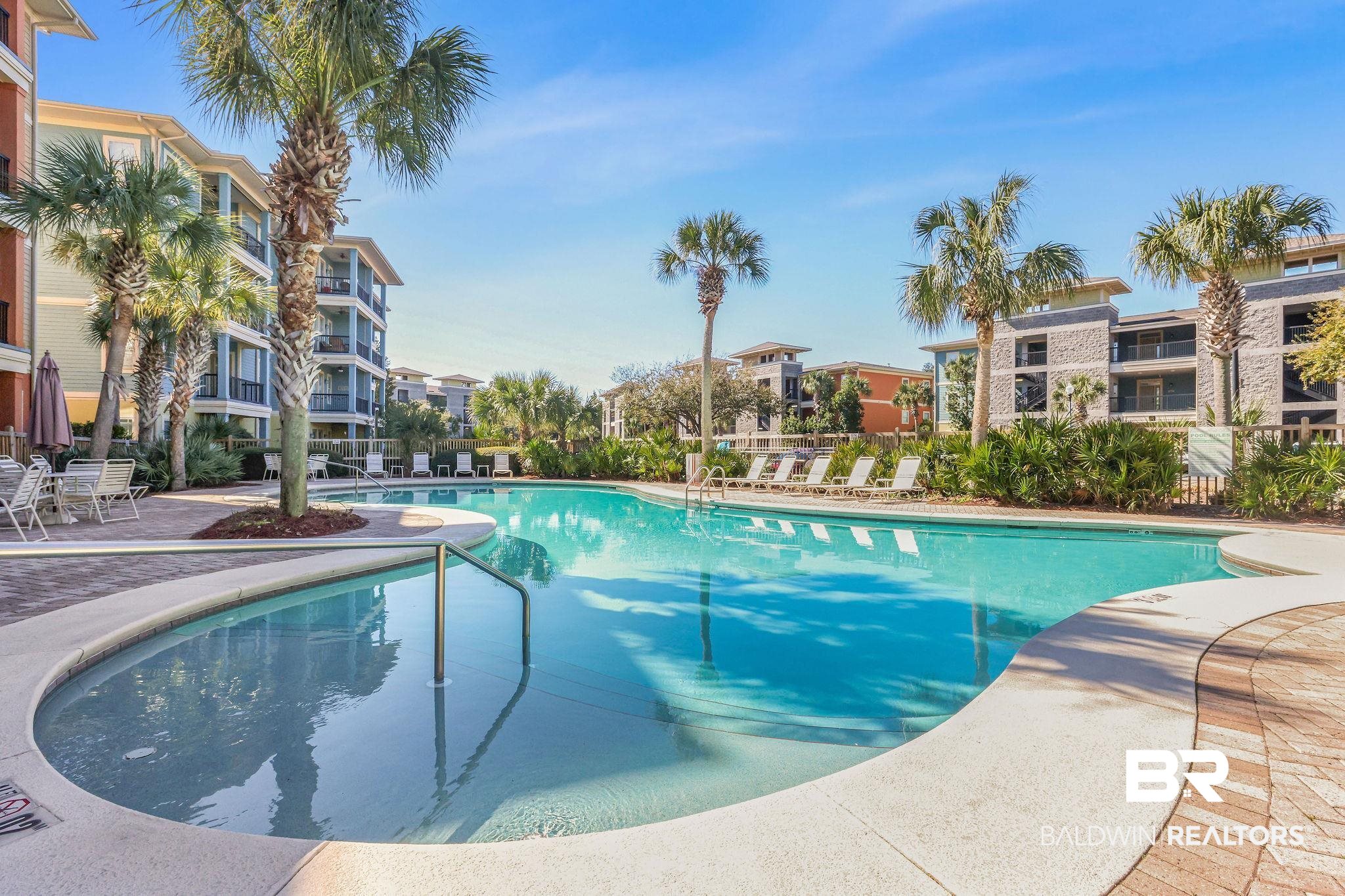 Pool featuring a patio and fence