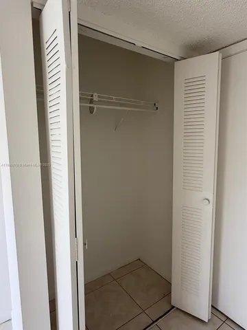 a view of an empty room and a window