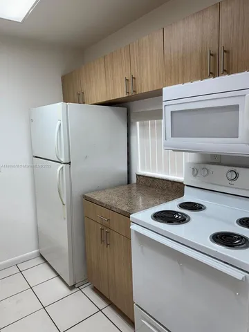 a kitchen with appliances and cabinets