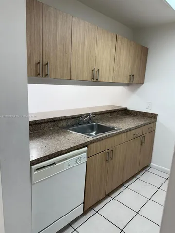 a kitchen with granite countertop cabinets and white appliances