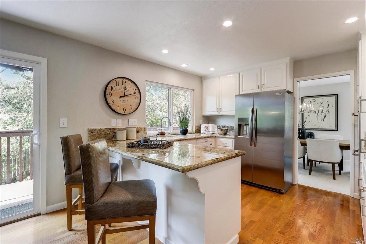 9 Fox Court Novato, CA 94945 - Photo 1 of 1 a kitchen with stainless steel appliances granite countertop a table chairs a refrigerator a stove a sink and a large window