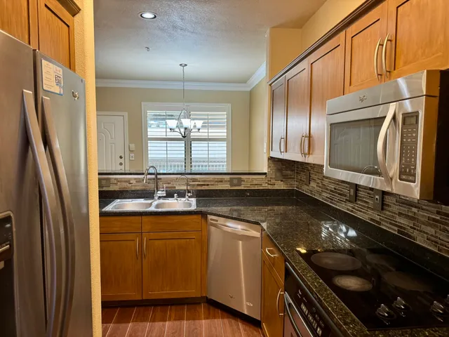 a kitchen with a sink stove and refrigerator