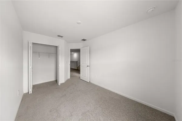 a view of an empty room and closet area